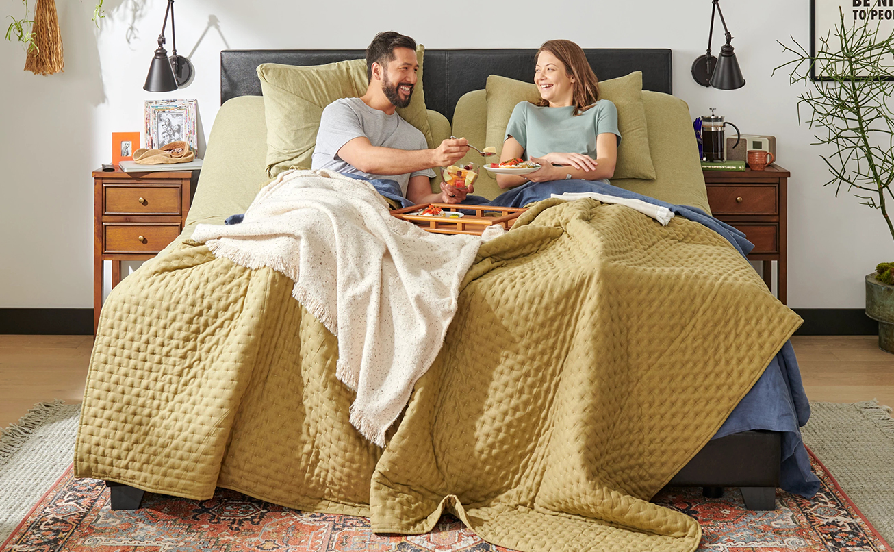 An image with a couple relaxing on their Tempur-Pedic mattress.